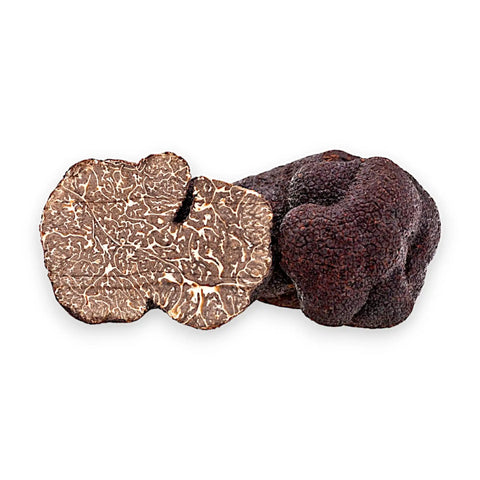 Black truffles, one sliced.