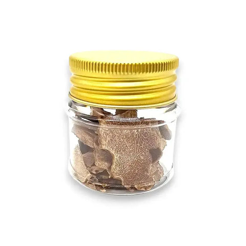 Clear glass jar with yellow lid containing slices of freeze dried white truffle Tuber Magnatum Pico