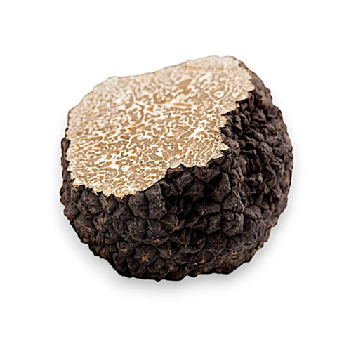 Rough black truffle with exposed marbled interior.